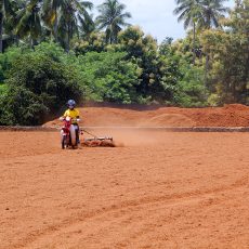 Turning the coir on the drying yards